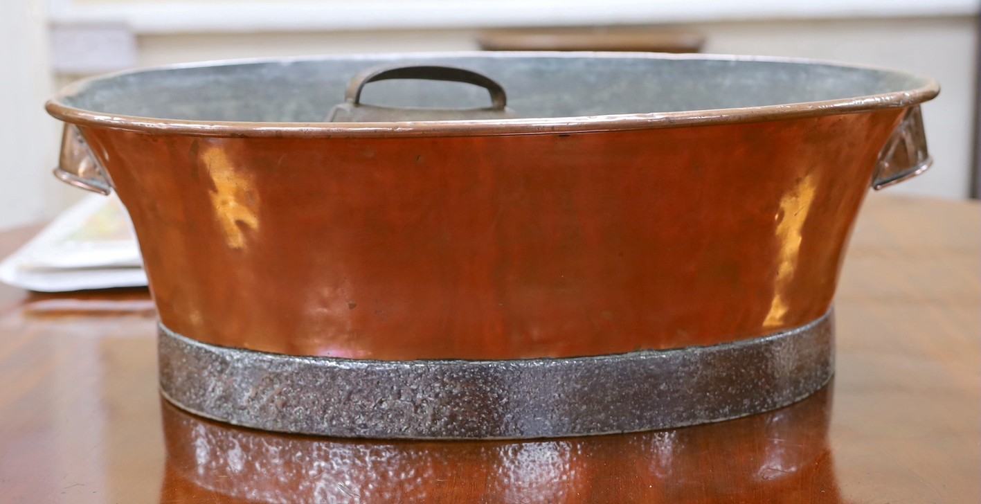 A copper twin handled pail and cow bells